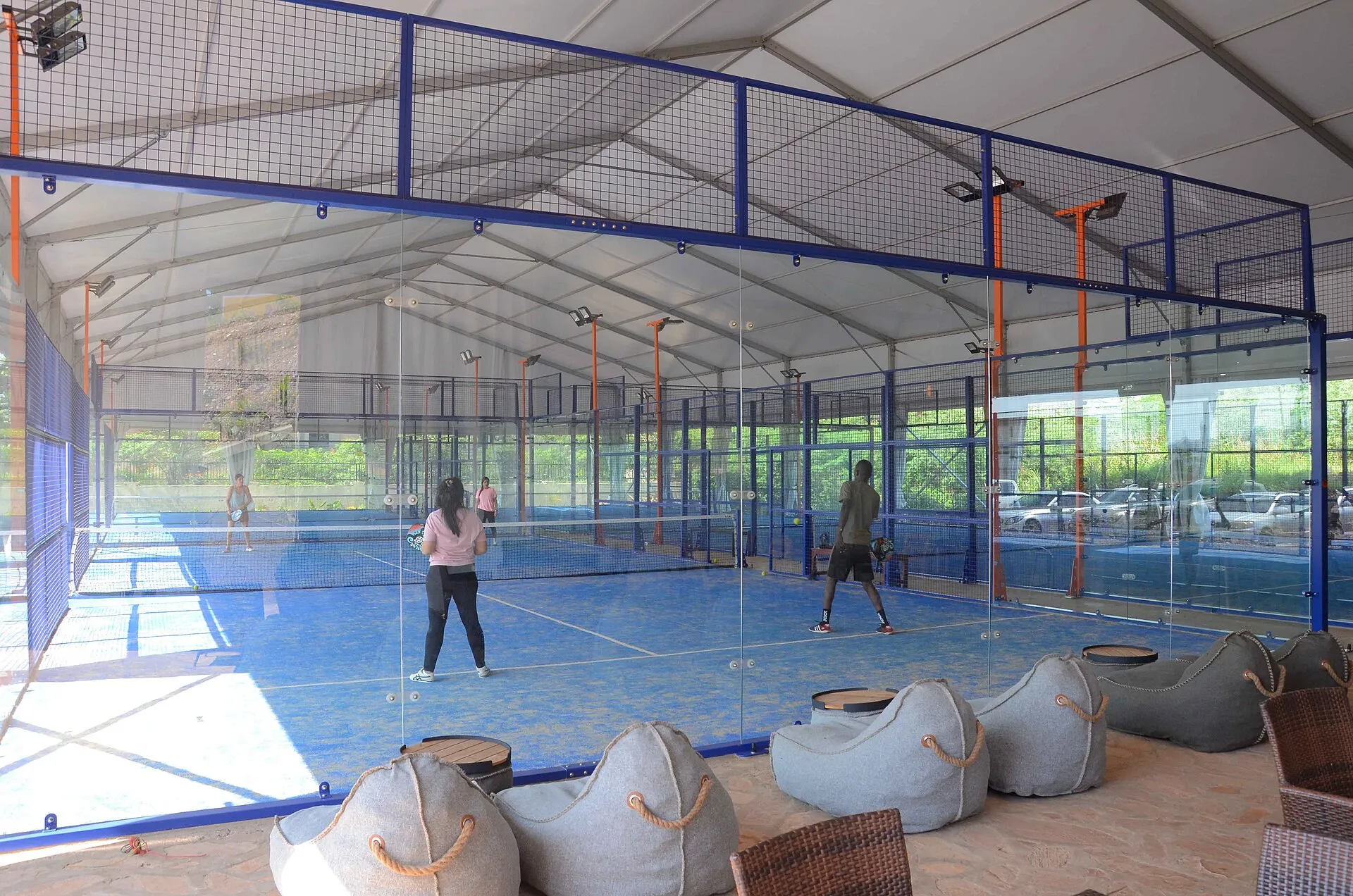 Two players on an indoor padel court